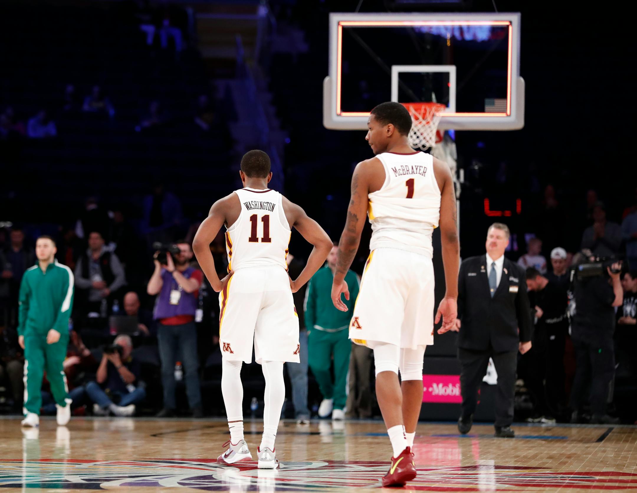 Minnesota guards Isaiah Washington (11) and Dupree McBrayer (1) walk off the court after the team's NCAA college basketball game against Rutgers in the first round of the Big Ten men's tournament, Wednesday, Feb. 28, 2018, in New York. Rutgers won 65-54. (AP Photo/Kathy Willens)