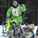 Ryan Redington pumped his fist as his crossed the finish line and officially winning the John Beargrease sled dog marathon on Tuesday evening in Grand