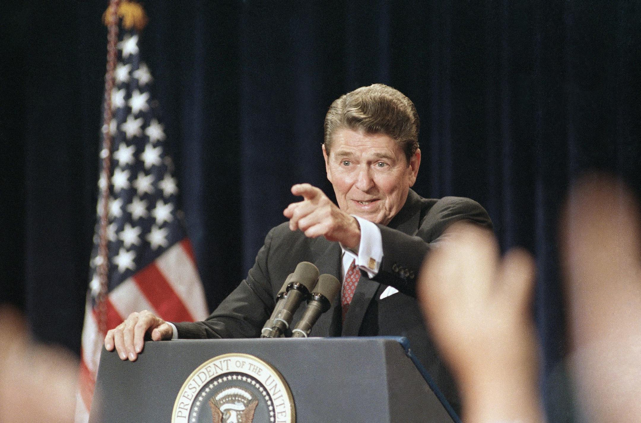 President Ronald Reagan points to raised hands during a rare national address outside the White House on Tuesday, August 12, 1986 in Rosemont, Illinois. (AP Photo/Scott Applewhite) ORG XMIT: APHS273831