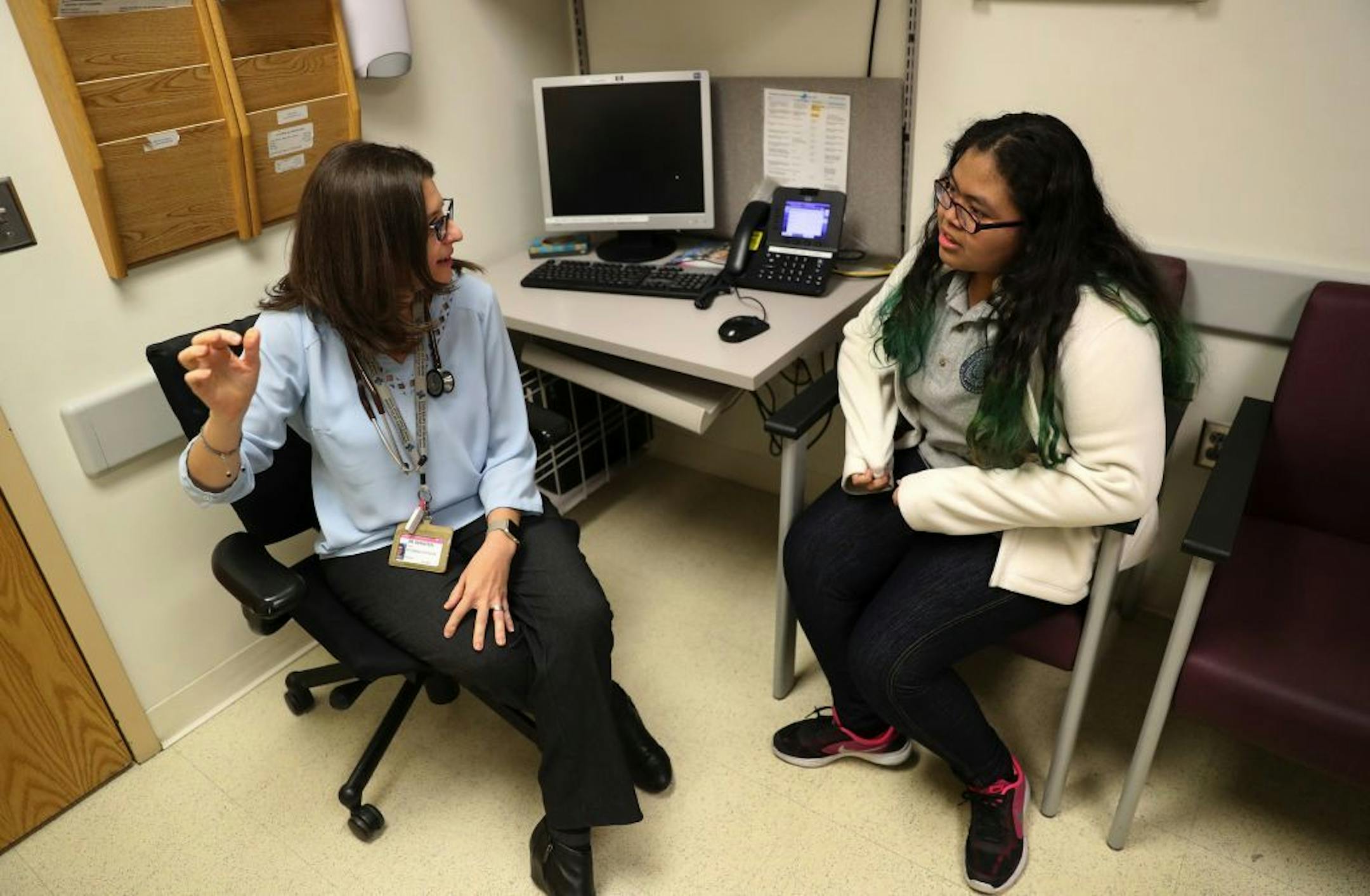 Kimberlyn Garcia, right, meets alone with pediatrician Dr. Karen Bernstein prior to the 13-year-old's mother, Gloria Garcia, joining them during an appointment on November 20, 2018.