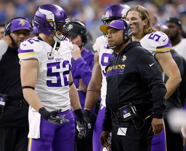 Minnesota Vikings outside linebacker Chad Greenway (52) talks with defensive coordinator George Edwards during the second half of an NFL football game