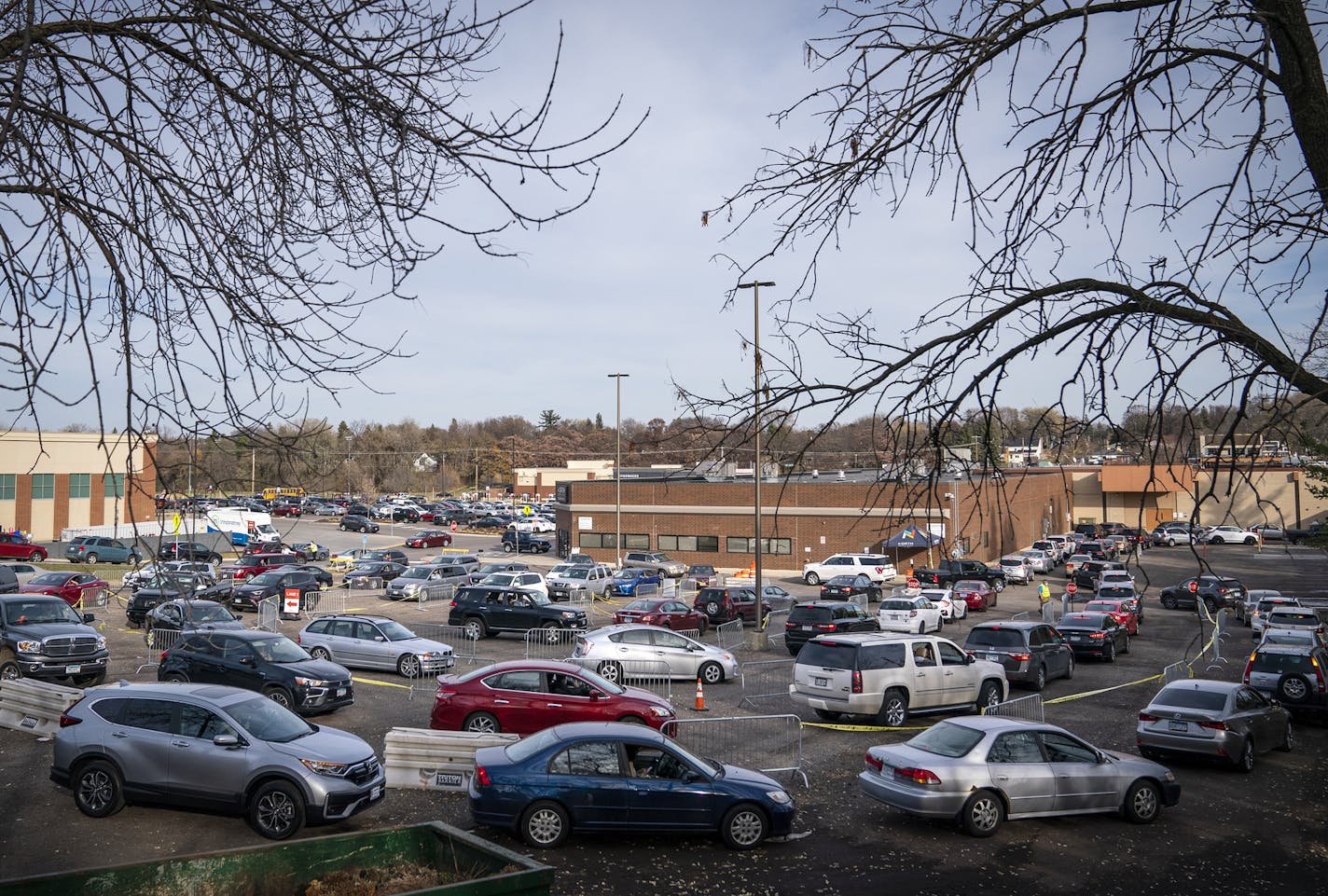 A line of cars winds through the parking lot area and out onto France Avenue North during drive-through COVID-19 testing at North Memorial Health in Robbinsdale. ] LEILA NAVIDI • leila.navidi@startribune.com BACKGROUND INFORMATION: Drive-through COVID-19 testing at North Memorial Health in Robbinsdale on Friday, November 6, 2020. The facility tested a total of 744 people Friday.