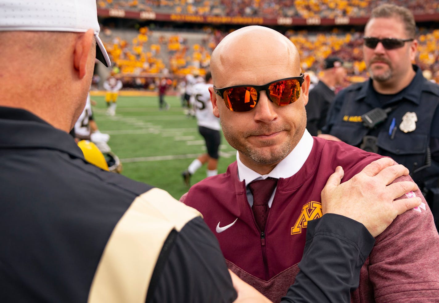 Purdue Boilermakers head coach Jeff Brohm shakes hands with Minnesota Gophers head coach P.J. Fleck after the game Saturday, Oct. 1, 2022 at Huntington Bank Stadium in Minneapolis, Minn. ]