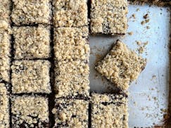 A pan of chocolate oat bars cut into squares to feed a crowd.