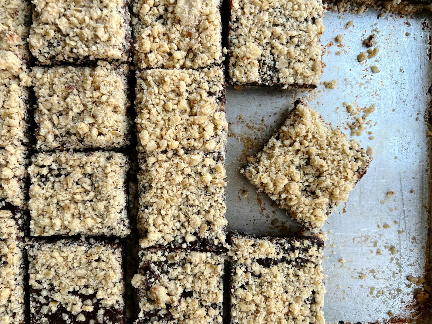 A pan of chocolate oat bars cut into squares to feed a crowd.