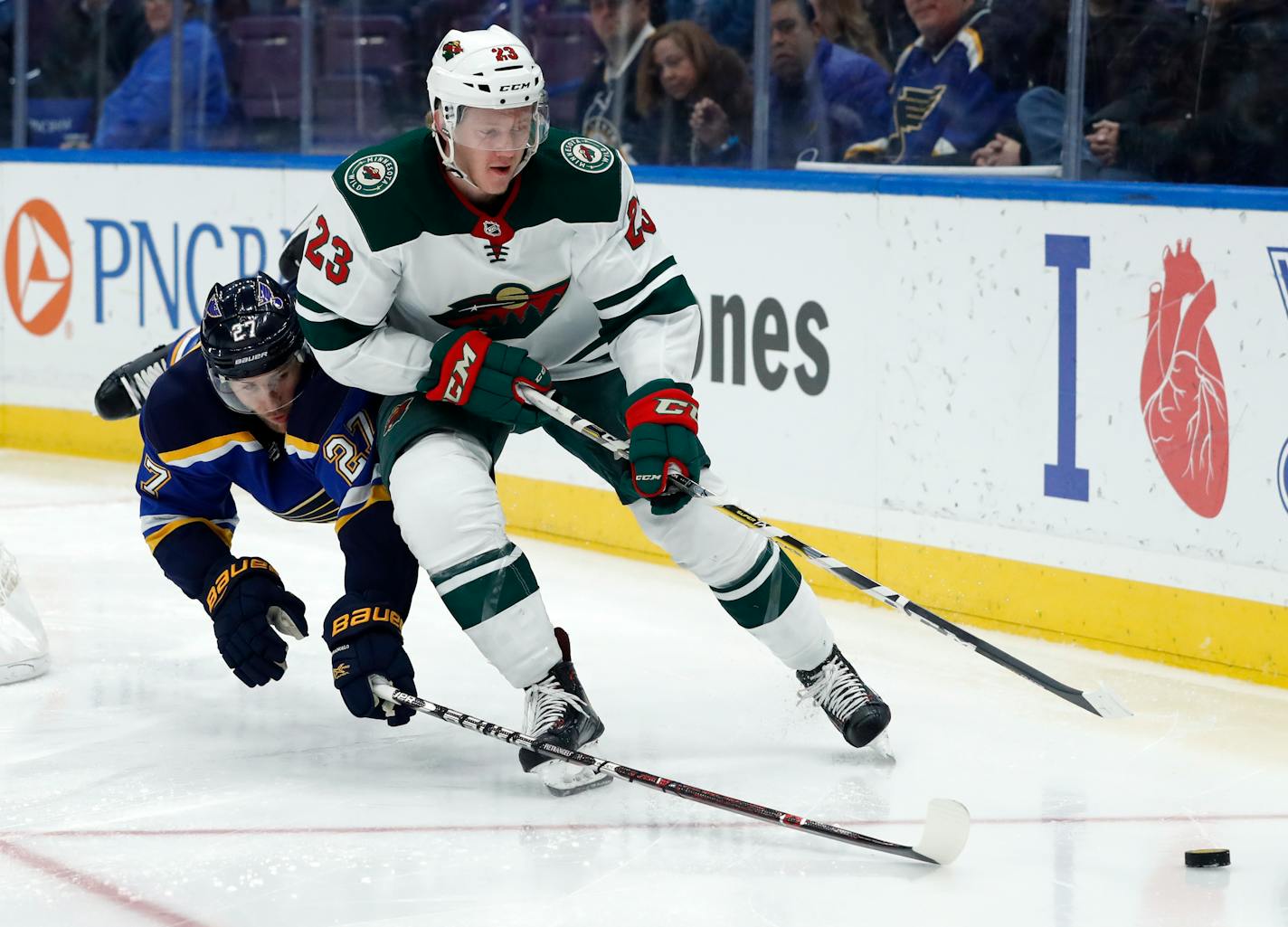 The Wild's Gustav Olofsson (23) and the Blues' Alex Pietrangelo chased after a loose puck along the boards during the third period Tuesday night.