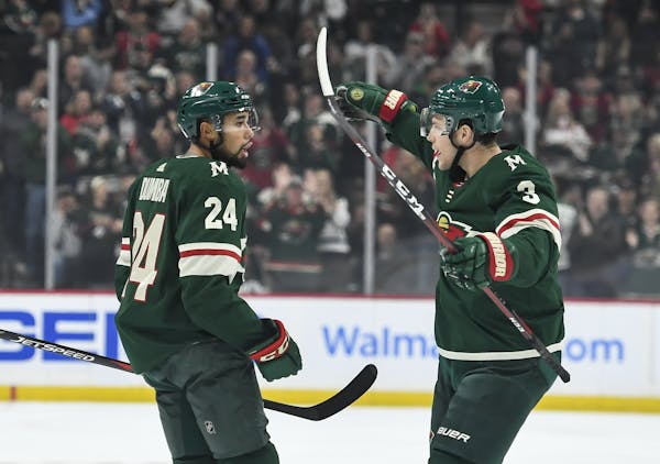 Minnesota Wild defenseman Matt Dumba (24) and center Charlie Coyle (3) celebrated a goal by Dumba in the first period against the Vegas Golden Knights