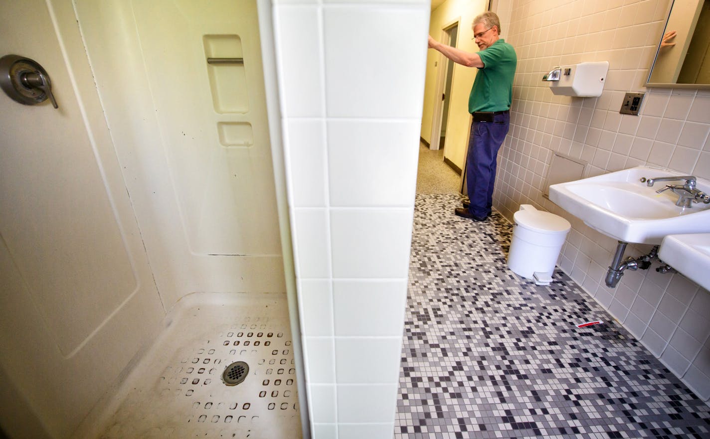 Clark Thomas, facilities and operations manager at Pioneer Hall, showed a bathroom with one shower that serves about 30 students at the oldest dorm on the University of Minnesota's Twin Cities campus.