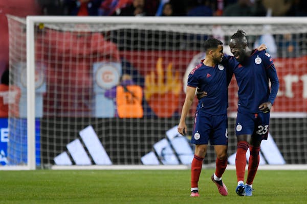 Chicago Fire forward Kei Kamara (23) celebrates with teammate Miguel Navarro (6) after scoring a goal against Minnesota United during the first half o