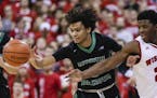North Dakota's Geno Crandall, left, and Wisconsin's Khalil Iverson (21) vie for a loose ball during the first half of an NCAA college basketball game,