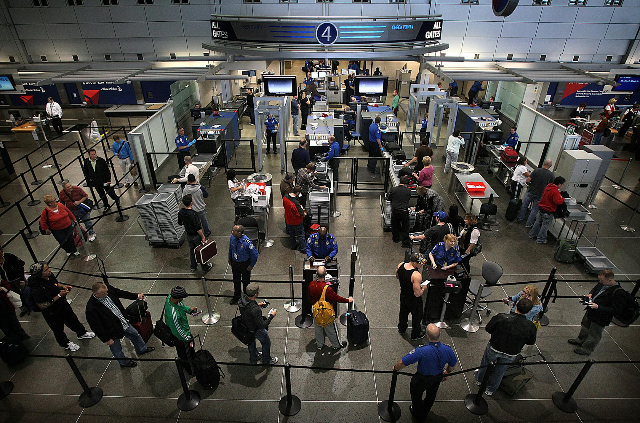 Travelers waited in line to pass through a TSA security checkpoint at Minneapolis-St. Paul International Airport.