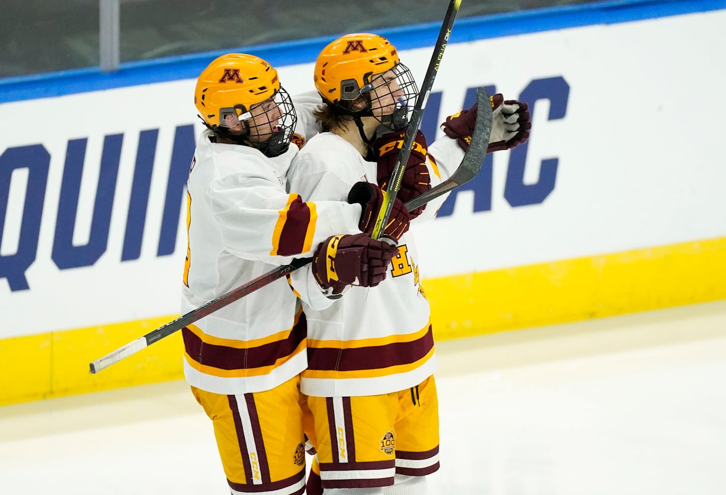 Minnesota defenseman Brock Faber, left, hugs defenseman Ryan Johnson, who scored a goal against Omaha during the second period of an NCAA West Regional college hockey semifinal Saturday, March 27, 2021, in Loveland, Colo. (AP Photo/David Zalubowski)